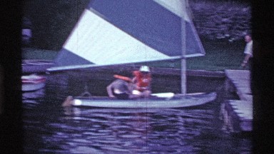 1969: people parking a sailboat at a pier OHIO