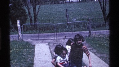 1969: a boy pulling up three children with help of small vehicle OHIO