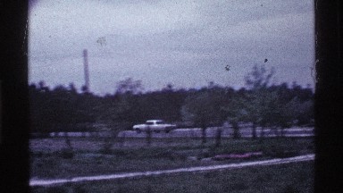 1969: a white car is seen driving at a high speed in a residential area OHIO