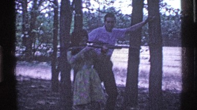 1969: a woman holds a gun while her husband leans against a tree. OHIO