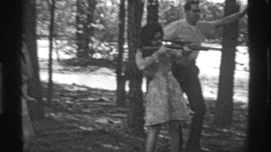 1969: young lady with her family in a forest hunting deer with a big gun. OHIO