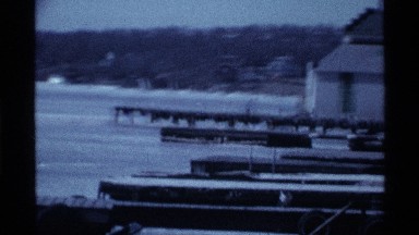 1969: adults and children skate and walk on one side of frozen lake OHIO