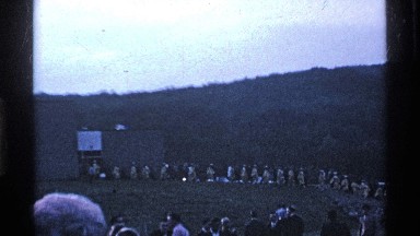 1969: workers marching out of facility in unison while people watch them down