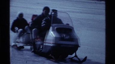 1969: driver on snowmobile has passenger and attached cart pulling two more OHIO