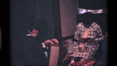 1969: two ladies with their kid are talking at their home and doing something