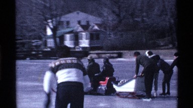 1969: some person skating to ice bar sit in the machine car in glass attach