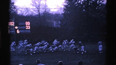 1969: sports at the ground with more guys at the evening time the score board