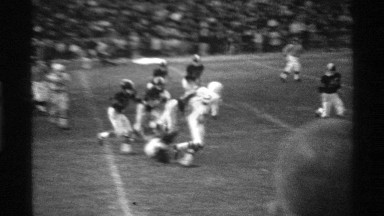 1969: sports people are playing sports at the open ground they all wear head