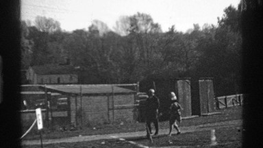 1969: the men and women walk the morning time near green grasses tree house