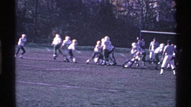 1969: a football match play in the ground run the player follow the ball people