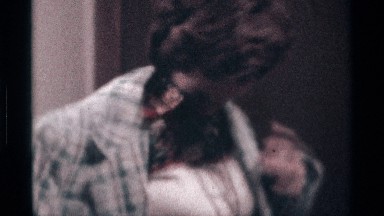 1976: woman puts a jacket on and shakes fist of money. KENTUCKY