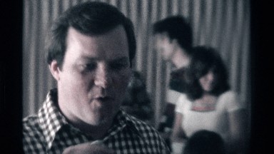 1976: a man in a black and white checkered shirt talks to the camera KENTUCKY