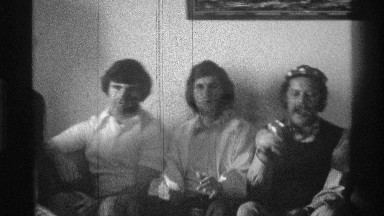 1976: men gathered around celebrating and enjoying a good time drinking alcohol
