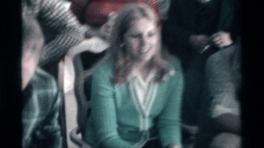1976: a group of the person men and women sing the song sit the place in a chair
