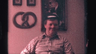1976: a man in a tiny hat holding a drink, sings into a microphone KENTUCKY