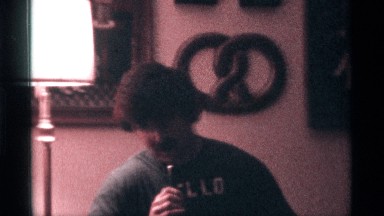 1976: a man speak to some question to answer our hand to mike our house wall