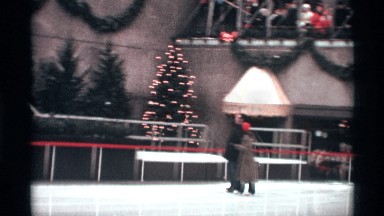 1970: a young couple skate on the ice at rockefeller plaza on a winter's day