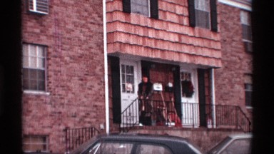 1970: the woman is standing outside the house NEW YORK CITY