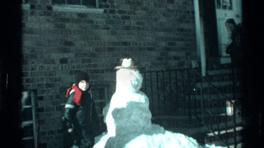 1971: child shows off his snowman with a hat that he had built NEW YORK CITY
