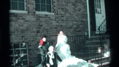 1971: kids playing and enjoying in snow by making a snowman in road side