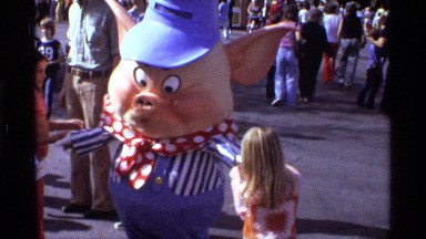 1974: a big toy men at the public place many children are played around him