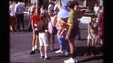 1974: several children together interacting with a theme park character ORLANDO