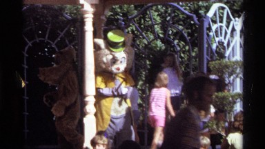 1974: theme park with cartoon character like dressed people dancing