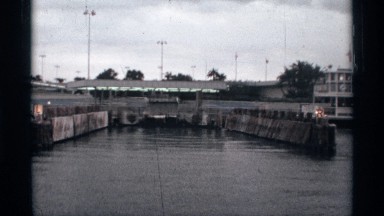 1974: the river near to building wall and back side tree and pillar light lamp
