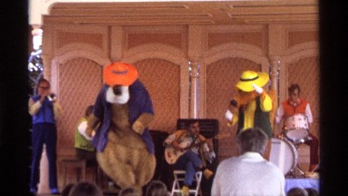 1974: the two mans wear a toy mask and acting in stage for entertain the peoples