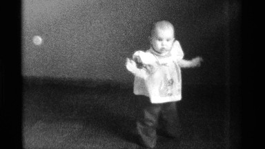 1976: a young, bald baby wobbles a bit as she walks around the room KENTUCKY
