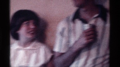 1976: a lot of people are at a house and celebrate party with wine and talking
