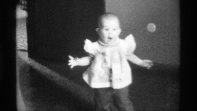 1976: toddler enters happily with mouth wide open and arms extended to sides