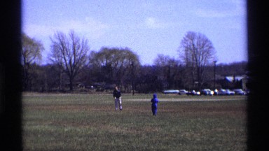 1969: father playing with his cute little son and playing football