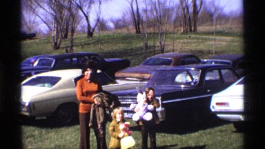 1969: a pretty woman in the parking lot of a game park with her two children