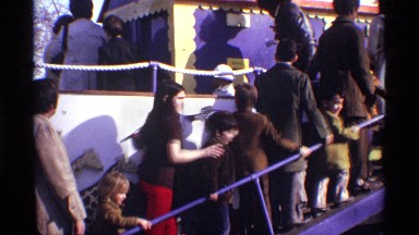 1969: a group of parents along with their children walking in line for an event