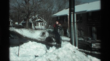 1971: the child playing the snow at the winter season wearing sweater