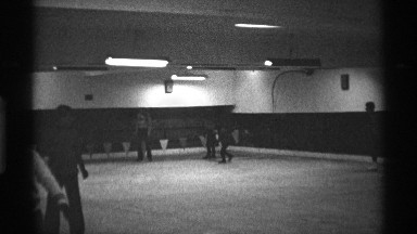1971: people and kids are using skating at a big size hall