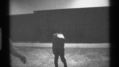 1971: two some person a small boy and men seems to be skating at a clear field