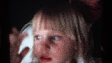 1971: a little boy and girl play in the our home near to mother sit in the place