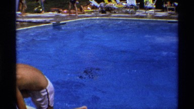 1971: children swim in a pool on a bright sunny day. NEW YORK