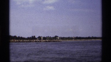 1971: panning view of the water and coastline taken from a moving boat. NEW YORK
