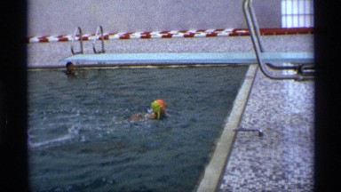 1971: a small girl swimming at the swimming pool and wake up from the pool