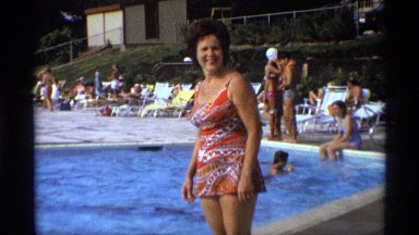 1971: A Middle-Aged Woman Walking Alongside the Pool Wearing a Dress