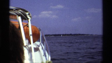 1971: view of sailboats on a lake from another boat. NEW YORK