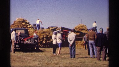 1969: many people seeing the processing place of straw by workers on open place