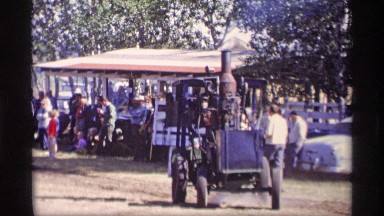 1969: man shows off his steam engine locomotive to a crowd of people