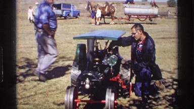 1969: a man doing something on a machine and some transports