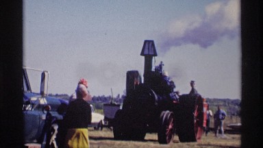 1969: tractor is running in an farm with lot of smoke in expansion