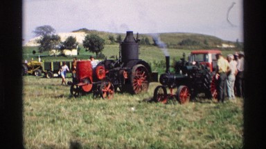 1969: old time steam engine tractor equipment on display for a crowd MABEL