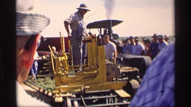1969: man demonstrates machinery causing him to move over elevated structure